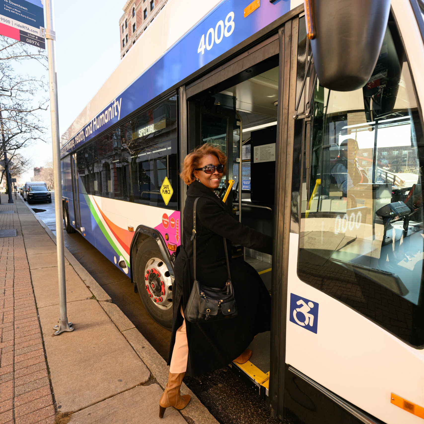 Image of a woman stepping on a GCRTA bus